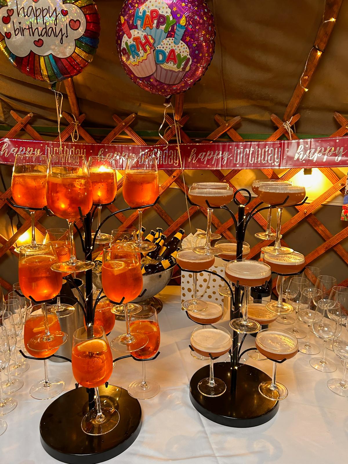Spritzes and martinis on stands ready for a birthday party in the yurt