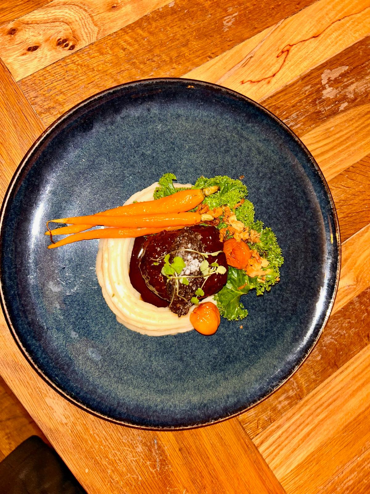 Glazed beef fillet with root vegetable mash, roasted carrots and crispy kale