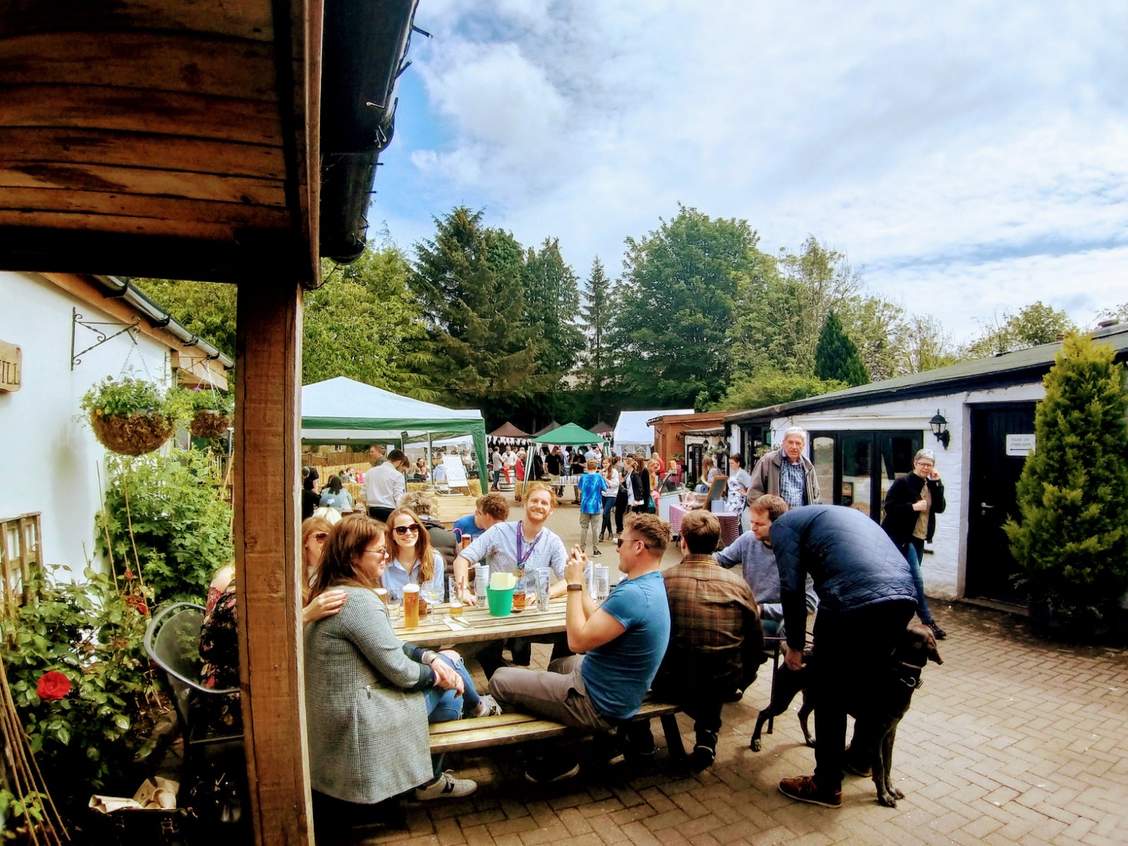 Guests enjoying drinks in the busy beer garden at The Old Mill