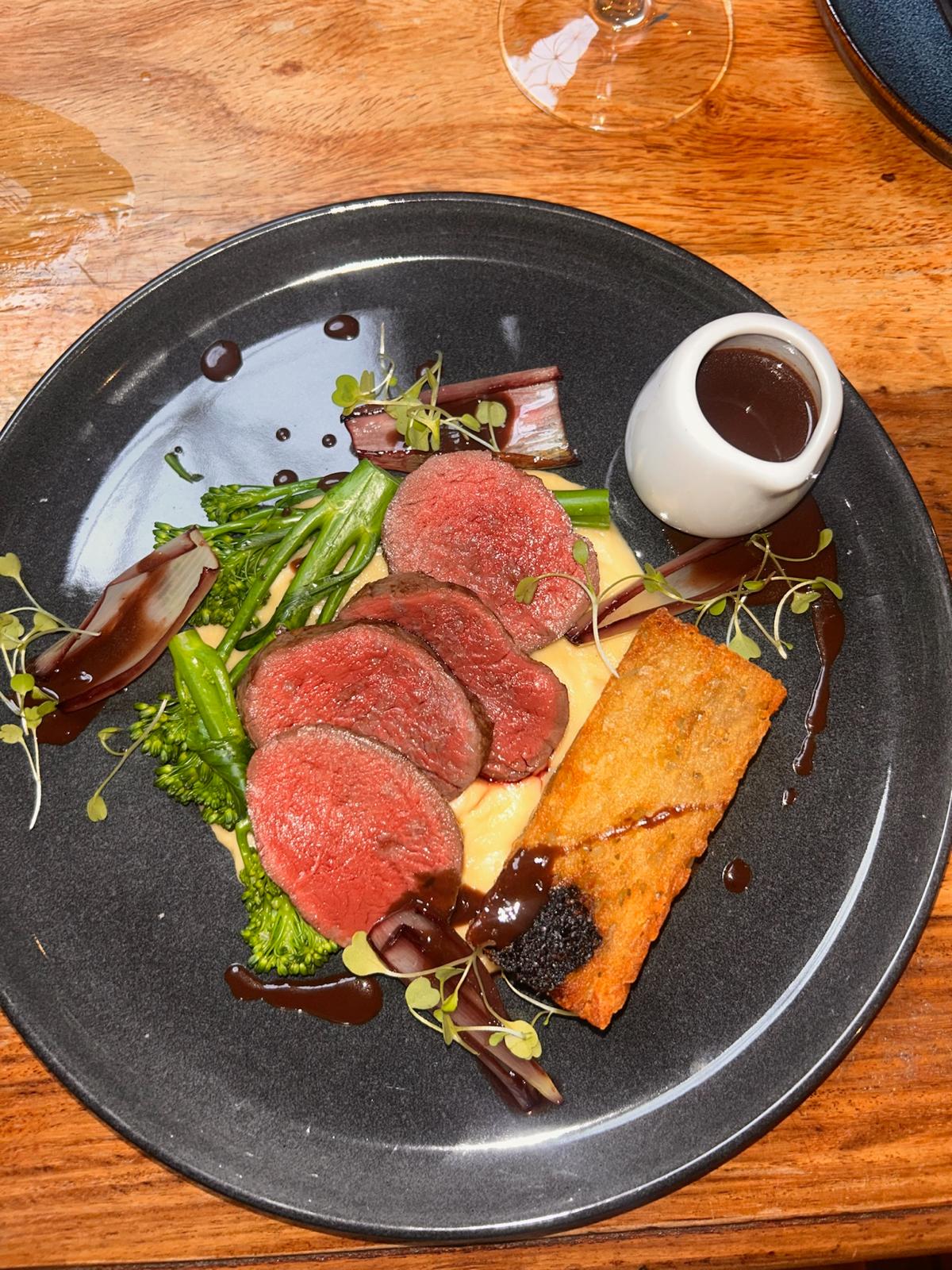 Sliced rump of beef with tenderstem broccoli, vegetable purée and a jug of jus